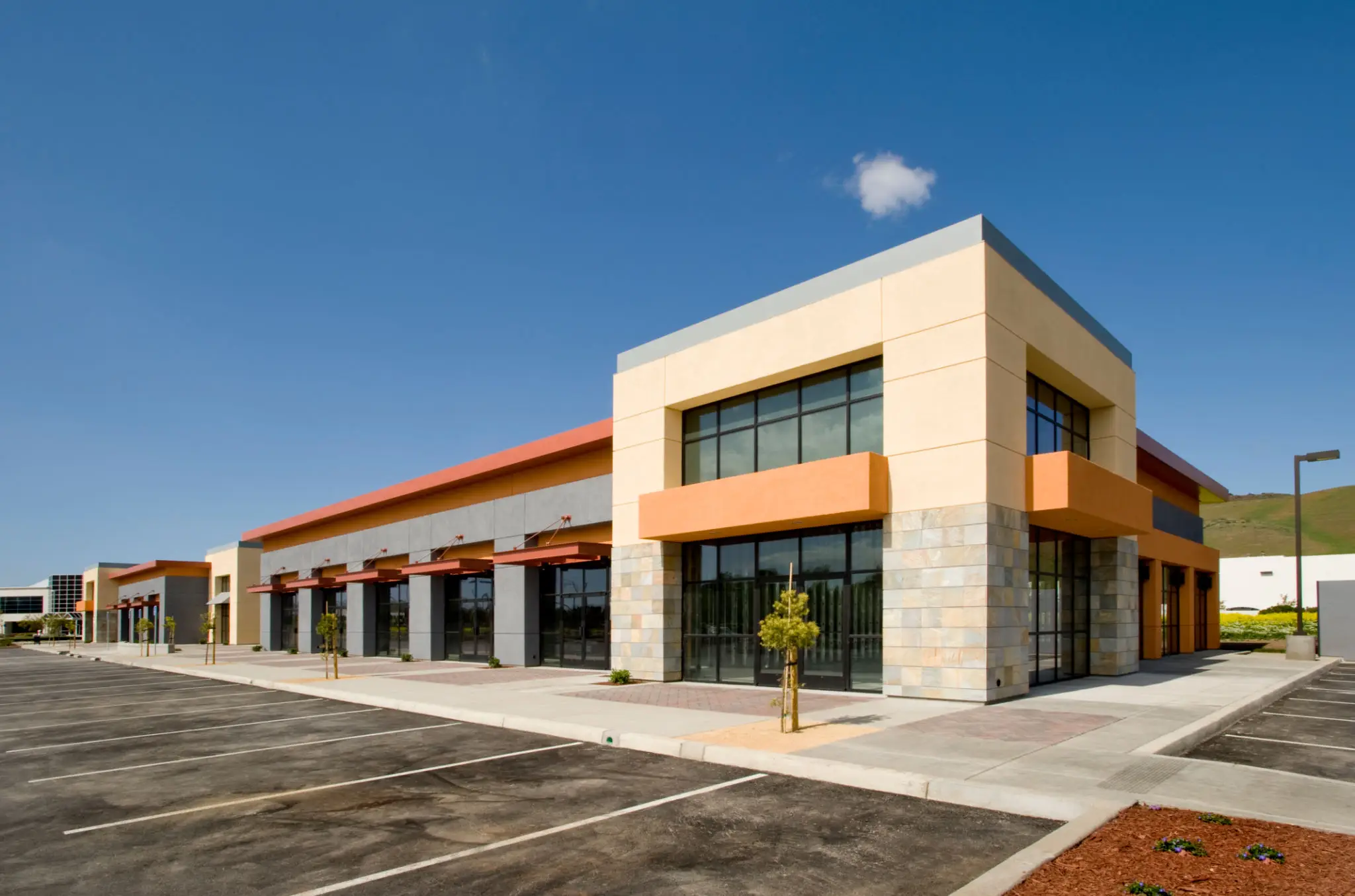 Modern commercial building with empty parking lot.